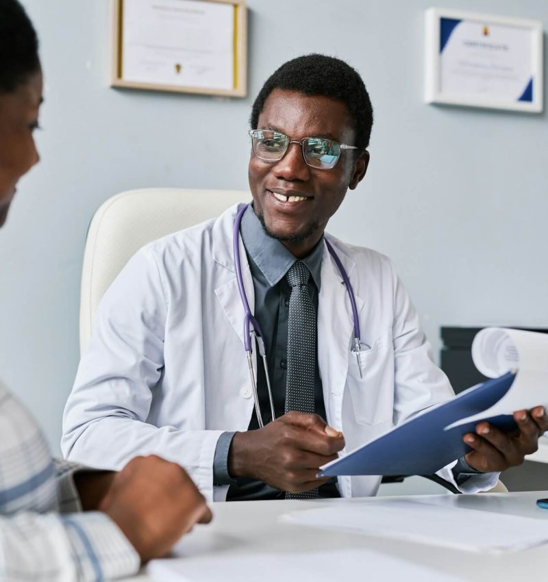 smiling-black-doctor-consulting-female-doctor-in-clinic.jpg